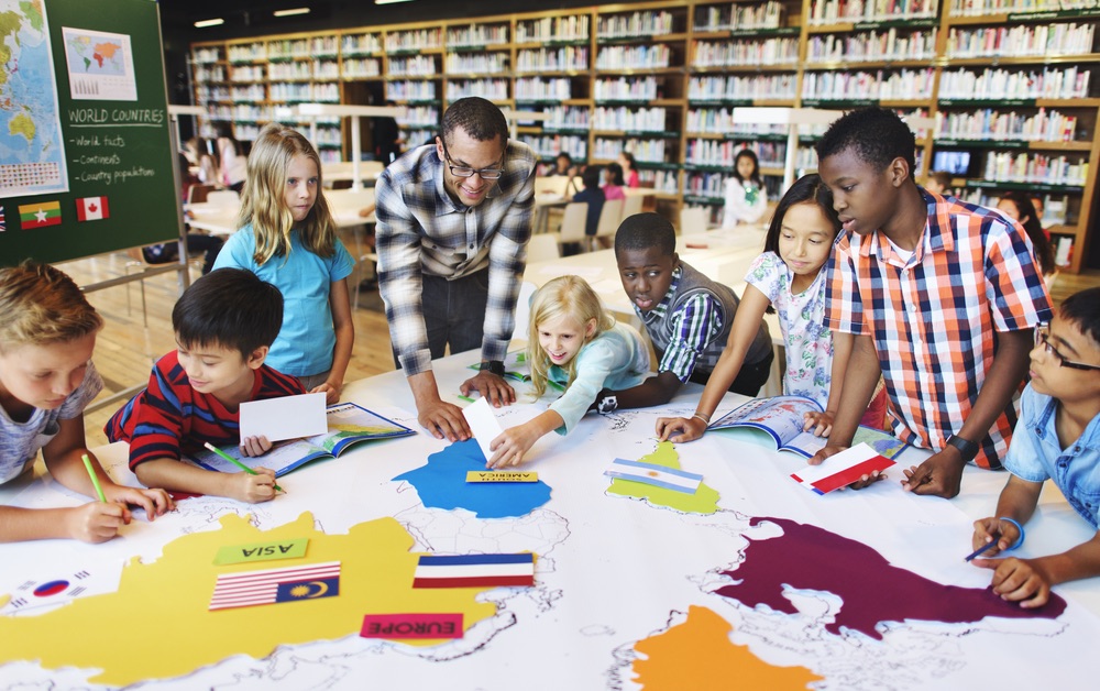 Young african-american male teacher working with a student groups